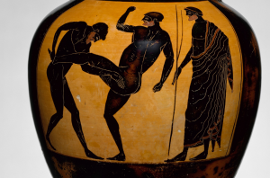 An Attic panathenaic prize amphora (c. 500 BCE) depicting an umpire watching the pankration, which was a combo of wrestling, boxing, and kicking (Picture via Wikimedia, but vase is at the Met NYC). 